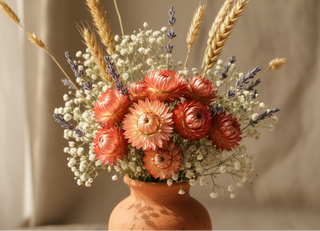 dried flower arrangement with salmon-colored strawflower helichrysum and a few other flowers