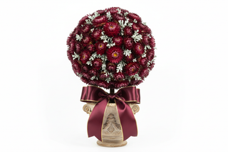 helichrysum strawflower topiary with dark red-purple flowers and a ribbon